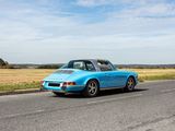 a blue car that is driving down the road