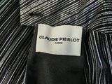 a close up of a black and white striped shirt with a label on it
