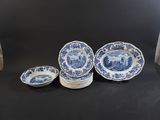 a group of blue and white plates sitting on top of a table