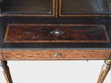 a small desk with a glass top and a drawer