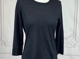 the top of a black shirt is on a mannequin stand