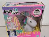 a box with a unicorn toy in it on a table