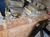 many empty glasses on the counter in the kitchen
