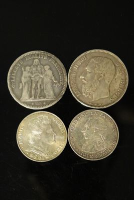 quatre types différents de pièces d'argent sur un fond noir