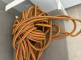 a rope that is laying on the floor next to a pair of shoes