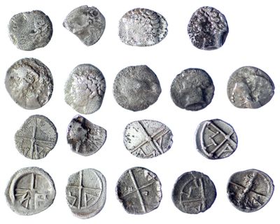 some silver coins are shown on a white surface
