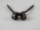 a small metal object that is on a white surface