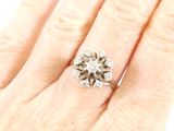 an image of a woman ' s hand with a diamond ring on it