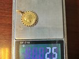a small scale with a gold coin on top of it