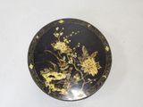 an image of a black and gold plate with flowers and birds
