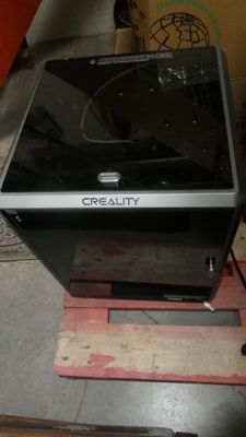 a black microwave sitting on a pallet in a garage