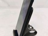a cell phone that is on a stand on a table