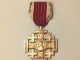 a gold medal with a red ribbon around it