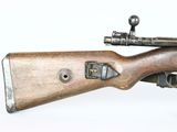an old rifle with a wooden barrel on a white background