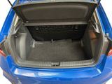 the back of a blue car with its trunk open showing the cargo compartment
