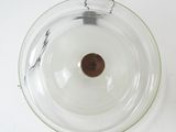 a glass bowl with a brown object inside of it