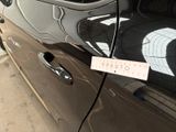 a car with a sticker on the side of it ' s door