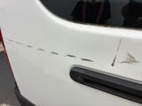 a white van with holes in the side of it