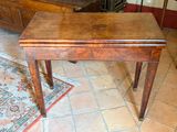 a small wooden table with a drawer on top of it