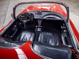 a red sports car with black leather seats and a steering wheel