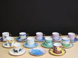 a lot of cups and saucers on the table