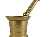 a brass mortar with a pestula in it on a white background
