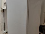 a white refrigerator sitting in the corner of a kitchen