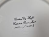 a close up of a white plate with a black writing on it