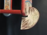 a close up of a wooden toy horse with a shell on it