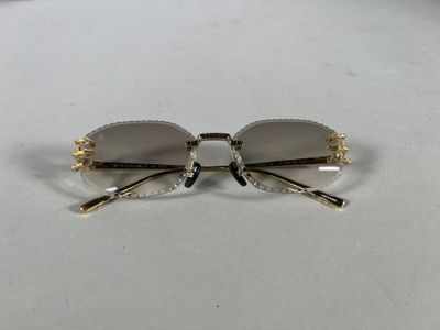 gold rimmed glasses with clear lenses on a white surface