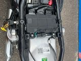 a motor bike with a battery in the back of it