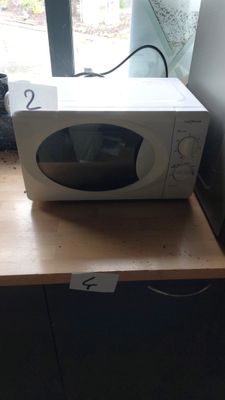 a microwave sitting on top of a wooden counter