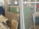 several pieces of wood are stacked on top of a metal cage