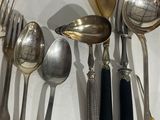 a lot of spoons and spoon spoons on the table