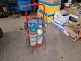 a cart with two gas cylinders on it in a garage