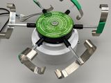 an image of a green and silver device on a white surface