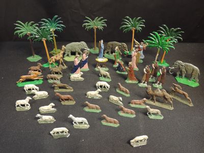 many figurines of animals and trees on the table