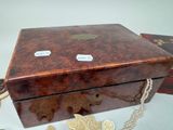 a wooden box with a chain around it on a table
