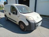 a small white van parked in front of a building