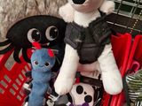 many stuffed animals in a basket on the floor