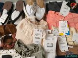 several pairs of shoes and clothes are laid out on a table