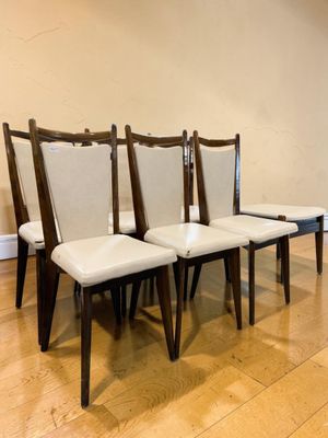 four chairs sitting in a row on a hard wood floor
