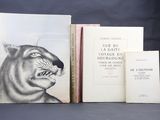 trois livres sont posés sur une table les uns à côté des autres