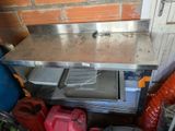 a stainless steel table with a metal shelf on it