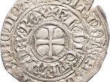 a close up of a coin with a cross on it