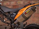 a motorcycle that is parked in front of a brick wall