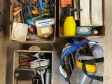 several boxes of tools and other items on the floor