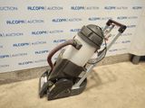a close up of a vacuum cleaner on the ground near a wall