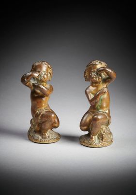 a pair of bronze figurines of a boy and a girl