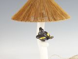 a lamp that has a bird on top of it